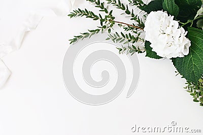 Festive wedding, birthday composition with eucalyptus parvifolia branches, hydrangea flowers and silk ribbon. White Stock Photo