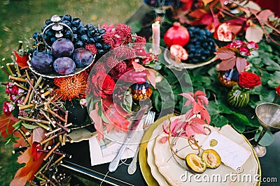 The festive wedding table with red autumn leaves. Wedding decoration. Artwork Stock Photo