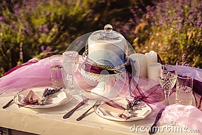 Festively served table with lavender bouquets and cake Stock Photo