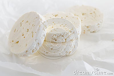 Feta cheese rounds on parchment paper Stock Photo