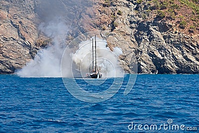 Fire on Turkish yacht in the Mediterranean Sea. White thick steam after discharge water to extinguish. Oludeniz,Fethiye,Mugla,Turk Editorial Stock Photo