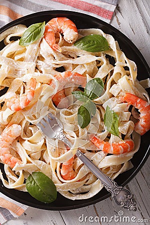 Fettuccini pasta in cream sauce with shrimp close-up. Vertical t Stock Photo