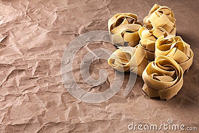 Fettucine Pasta on Brown Paper Background Stock Photo