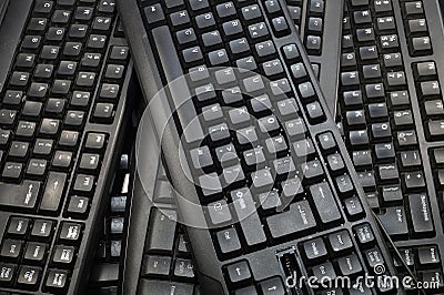 A few black computer keyboards. Horizontal frame. Stock Photo