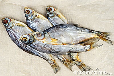 Few cured white-eye bream Ballerus sapa fishes on brown paper Stock Photo