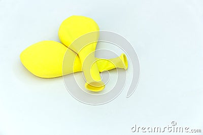A few deflated yellow balloons on white background Stock Photo
