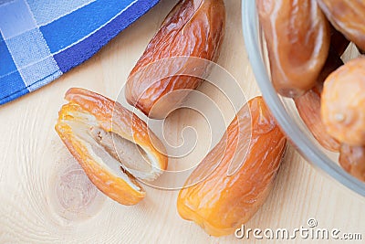 A few dried sweet deglet nour date fruites on wooden table Stock Photo