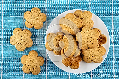 Few shortbread cookies, plate with cookies on blue tablecloth. Top view Stock Photo