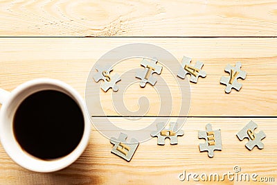 Few mockup puzzles and coffee cup on wooden background. Stock Photo