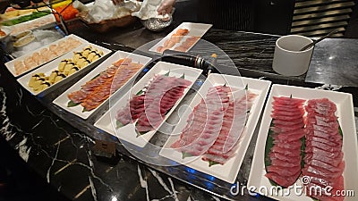 Few plates of raw fish on display table Stock Photo