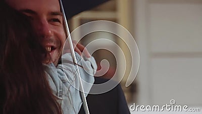 Few shots of adorable couple whirling, laughing, hugging in the city under the umbrella. Pretty young woman in a casual stock video Few shots of adorable couple whirling, laughing, hugging in the city under the umbrella. Pretty young woman in a casual stock video