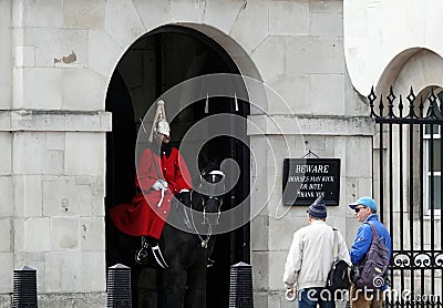 Few tourists standing and watching a mounted Royal Horse Guard on duty at Horseguards Parade Editorial Stock Photo