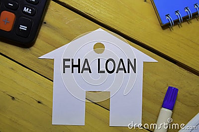 FHA Loan text on paper house isolated on office desk. Stock Photo