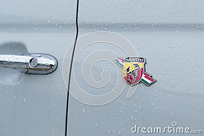 Fiat Abarth logo on a light gray car body. Close-up. Editorial Stock Photo