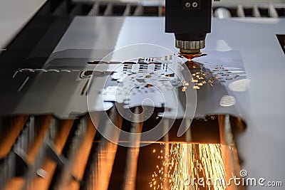 The fiber laser cutting machine cut the metal plate with the sparkling light Stock Photo