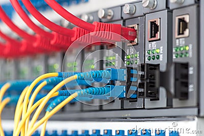 Fiber Optic cables connected to an optic ports Stock Photo