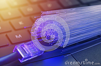 Fiber optics in blue, close up with ethernet and keyboard background, warm lens flare Stock Photo