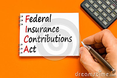 FICA symbol. Concept words FICA federal insurance contributions act on white note on beautiful orange background. Business FICA Stock Photo