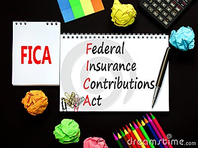 FICA symbol. Concept words FICA federal insurance contributions act on white note on beautiful black background. Business FICA Stock Photo