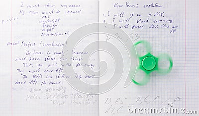Fidget spinner stress relieving toy on notebook background Stock Photo