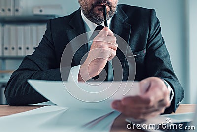 Fiduciary, agent carefully reading business papers in office Stock Photo