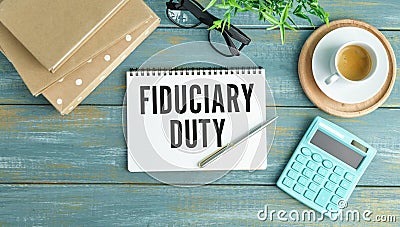 Fiduciary Duty. wooden light table. stationery.text on open notepad Stock Photo