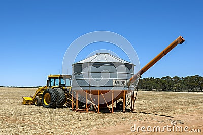 A field bin being towed by a tractor on a farm in Australia. Editorial Stock Photo