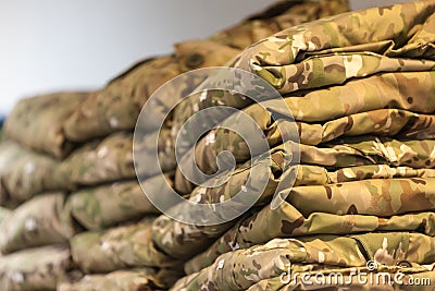 Field camouflage clothing on the shelf of a specialized warehouse-store for police and military uniforms Stock Photo