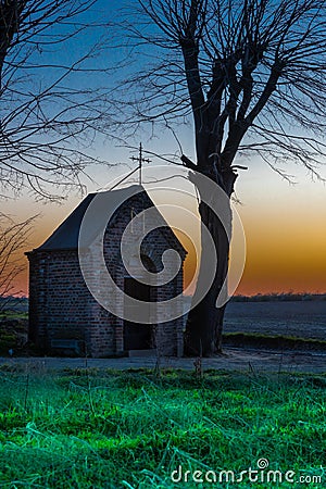 Field chapel of Our Lady of the Seven Sorrows in the field of Maastricht during sunset. Farmers used to pray here for good agricul Stock Photo