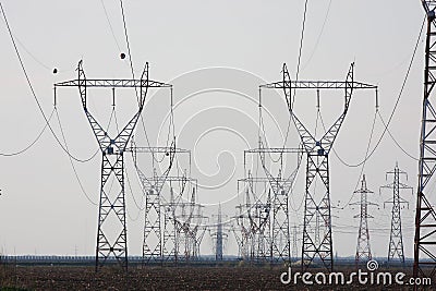 Field with high voltage pillars Stock Photo