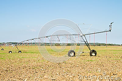 Field with pivot sprinkler system irrigation Stock Photo