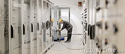 Field service engineer inspect relay protection system with laptop comput Stock Photo