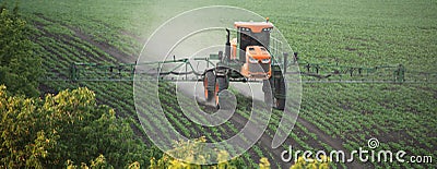 Field Transformation: Witnessing the Tractor's Spraying Expertise Stock Photo