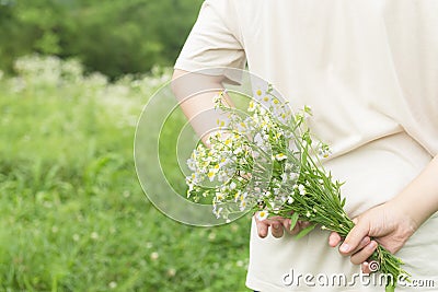 Field flowers bouquet in teens hand Stock Photo