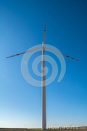 Field with windmills for electric power. Clean energy produced by the wind. Extraction of energy from the air Stock Photo