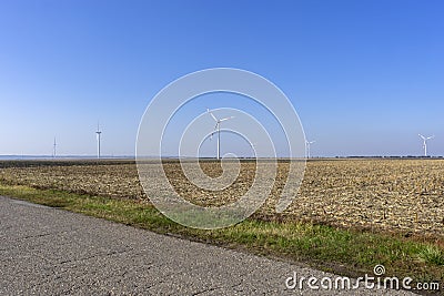 Field with windmills near the road Stock Photo