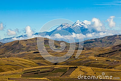 Fields cultivated in summer with Ilinizas volcano Stock Photo