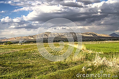 Darkened by spring storm clouds, the evening sky in the Ararat valley with the mountains of Gegham ridge visible in the distance Stock Photo