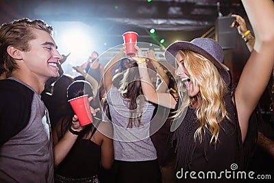 Fiends dancing in nightclub Stock Photo