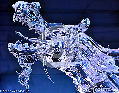 Fierce Roaring Dragon Ice Sculpture with blue backgroud Stock Photo