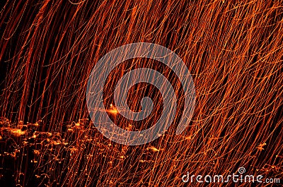 Fiery embers falling in darkness on river ice Stock Photo