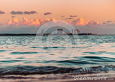 Fiery Farewell: Sun Dips Below Horizon in Dramatic Beach Sunset Stock Photo