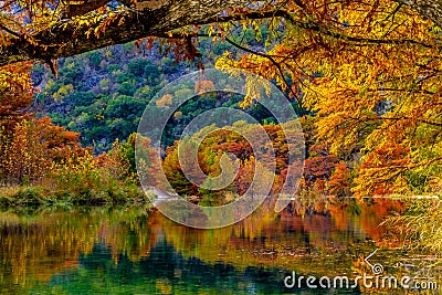 Fiery Orange Reflections on the Frio River at Garner State Park, Texas Stock Photo