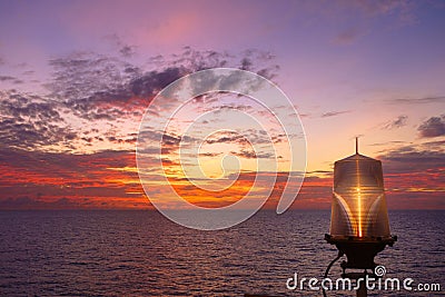 Fiery orange sunset sky warm light with clouds on the sea Beautiful for background with nav aids lamp on offshore oil and gas Stock Photo