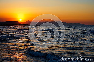 Fiery red sunset over a turbulent sea Stock Photo