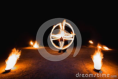 Fiery streaks during the fireshow at night Stock Photo