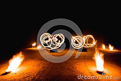 Fiery streaks during the fireshow at night Stock Photo