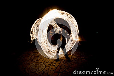 Fiery streaks during the fireshow at night Stock Photo