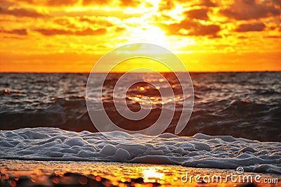 Fiery sunrise over the waves. Stock Photo