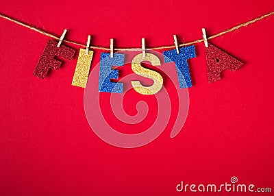 Fiesta word made of shiny paper and pins on red background. Cinco de mayo concept Stock Photo